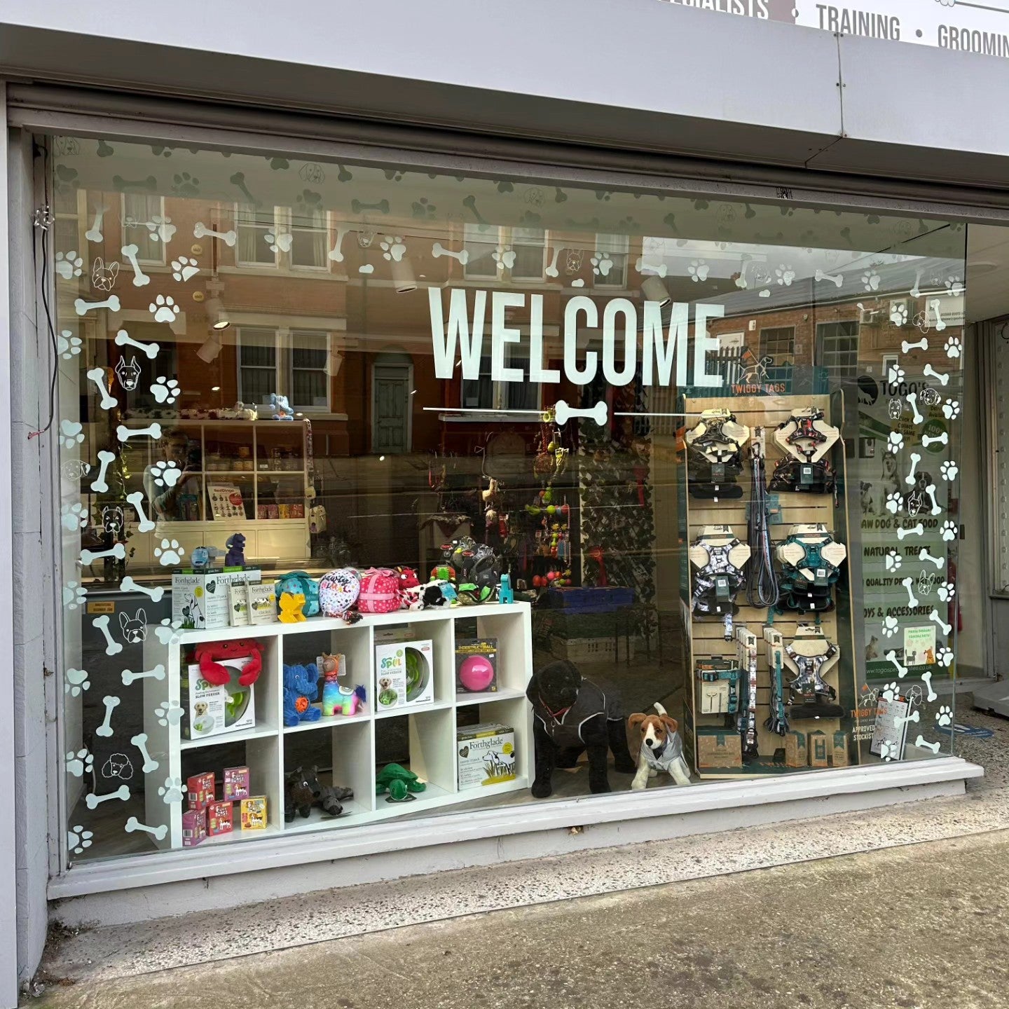 window graphic applied to shop window. Dog paws and bone in an arch 